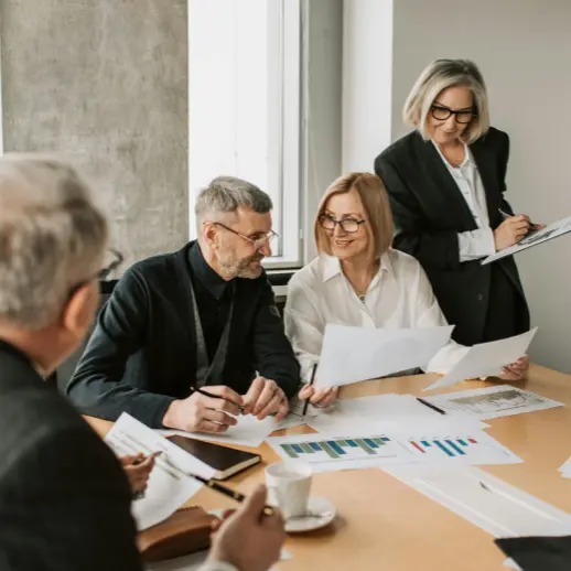 Woman with glasses explaining something in a modern office environment